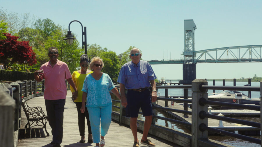 Group of seniors walking by water