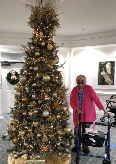 Senior woman in front of Christmas tree